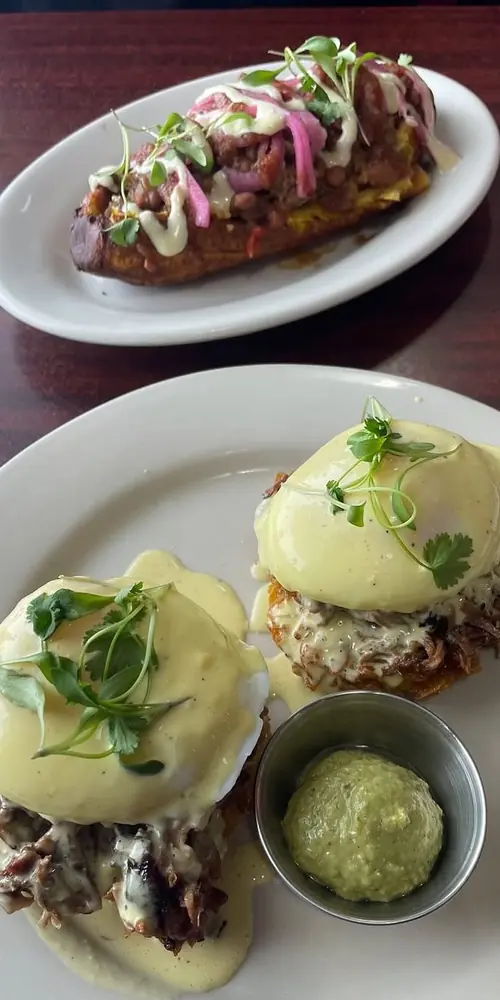 Our Tostones Benny has Crispy Plantain Hash-browns, Perfectly Poached Eggs and a silky Adobo Holland