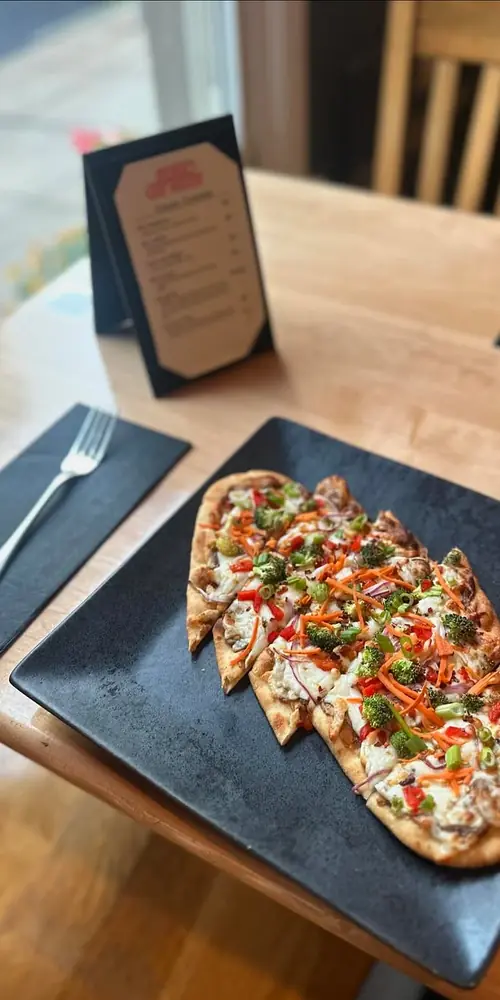 FLATBREAD SPECIAL: Thai peanut sauce base topped with mozzarella cheese, roasted red peppers, red o